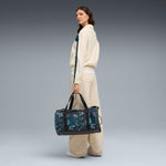 PUMA ESSENTIALS training green terrains 28.5L barrel bag in green terrain - Image 1