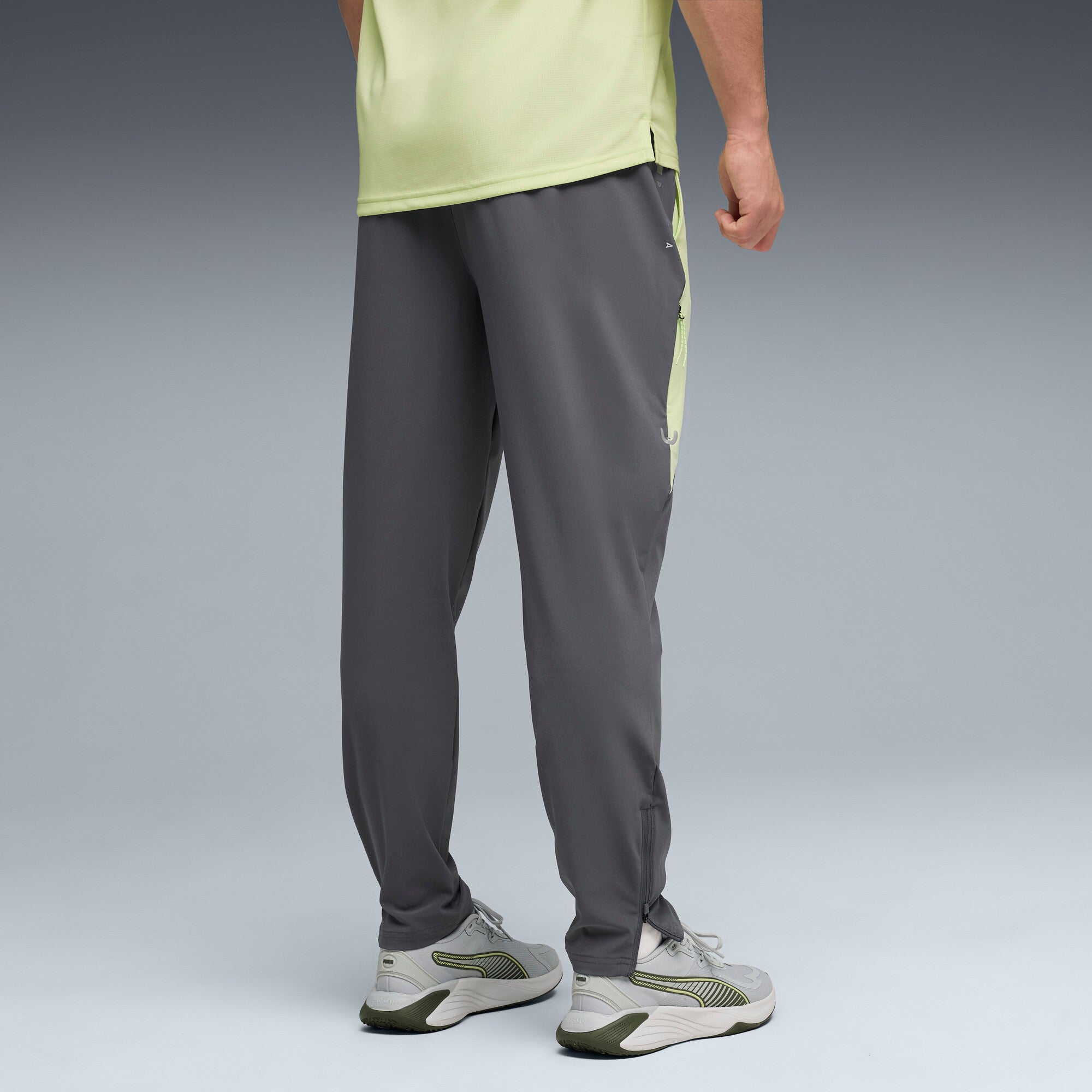 PUMA FLEX STRETCH woven training pants in gray and green — model shot 2