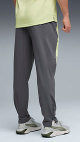 PUMA FLEX STRETCH woven training pants in gray and green — model shot 2