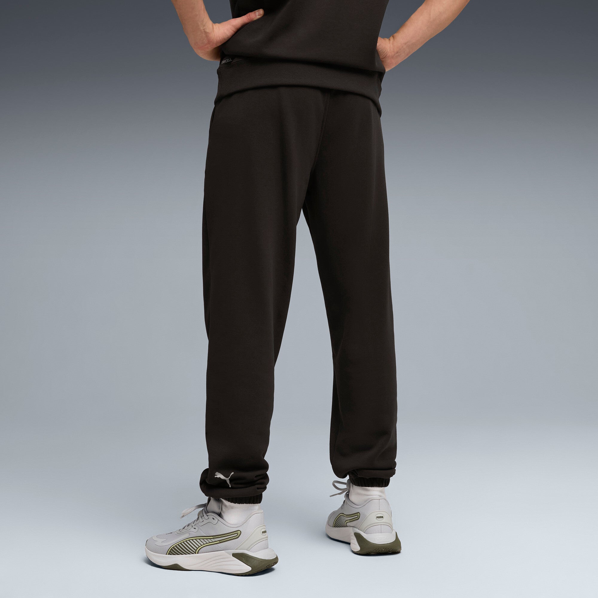 PUMA graphics training jogger pants men in black — model shot 2