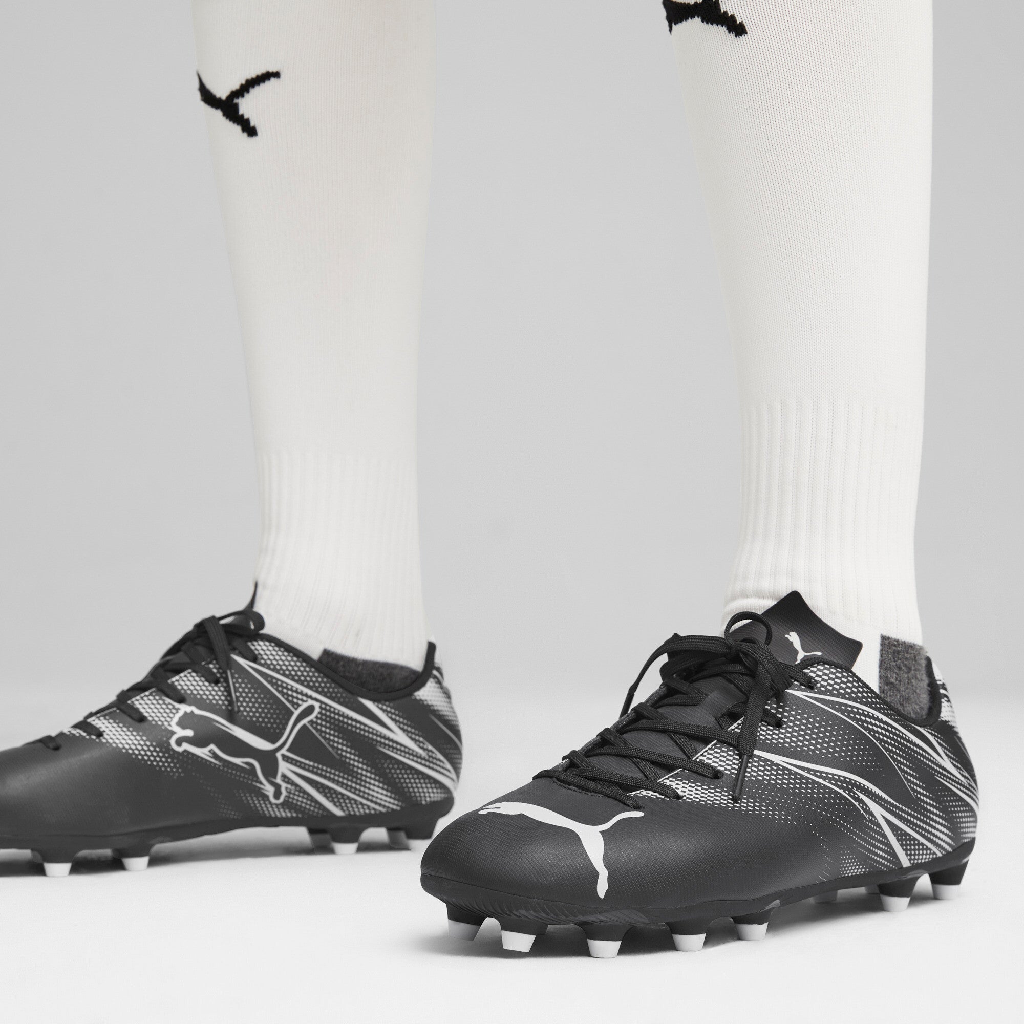 Puma football attacanto fg/ag boots in black - Model Shot 01