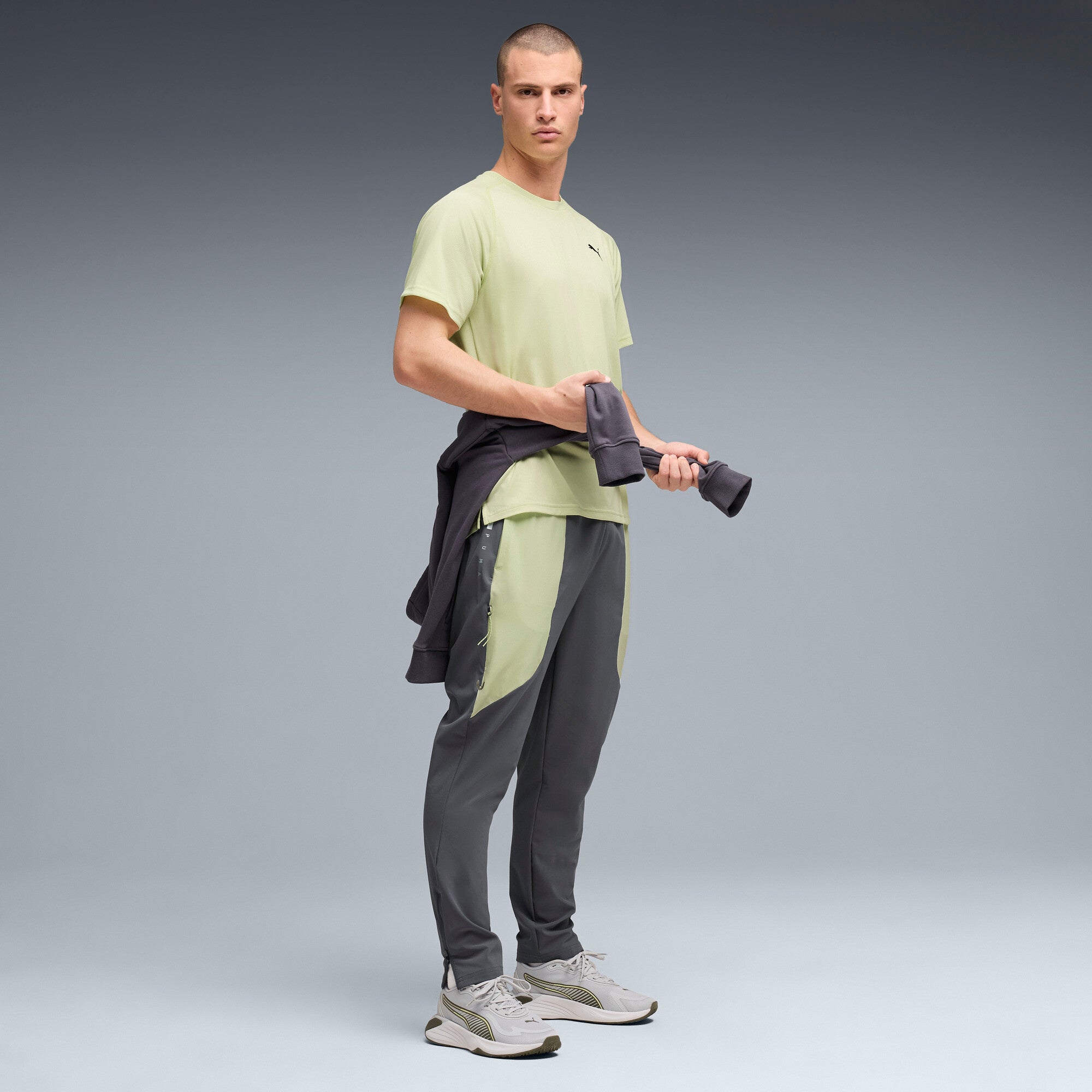 PUMA FLEX STRETCH woven training pants in gray and green — model shot 3