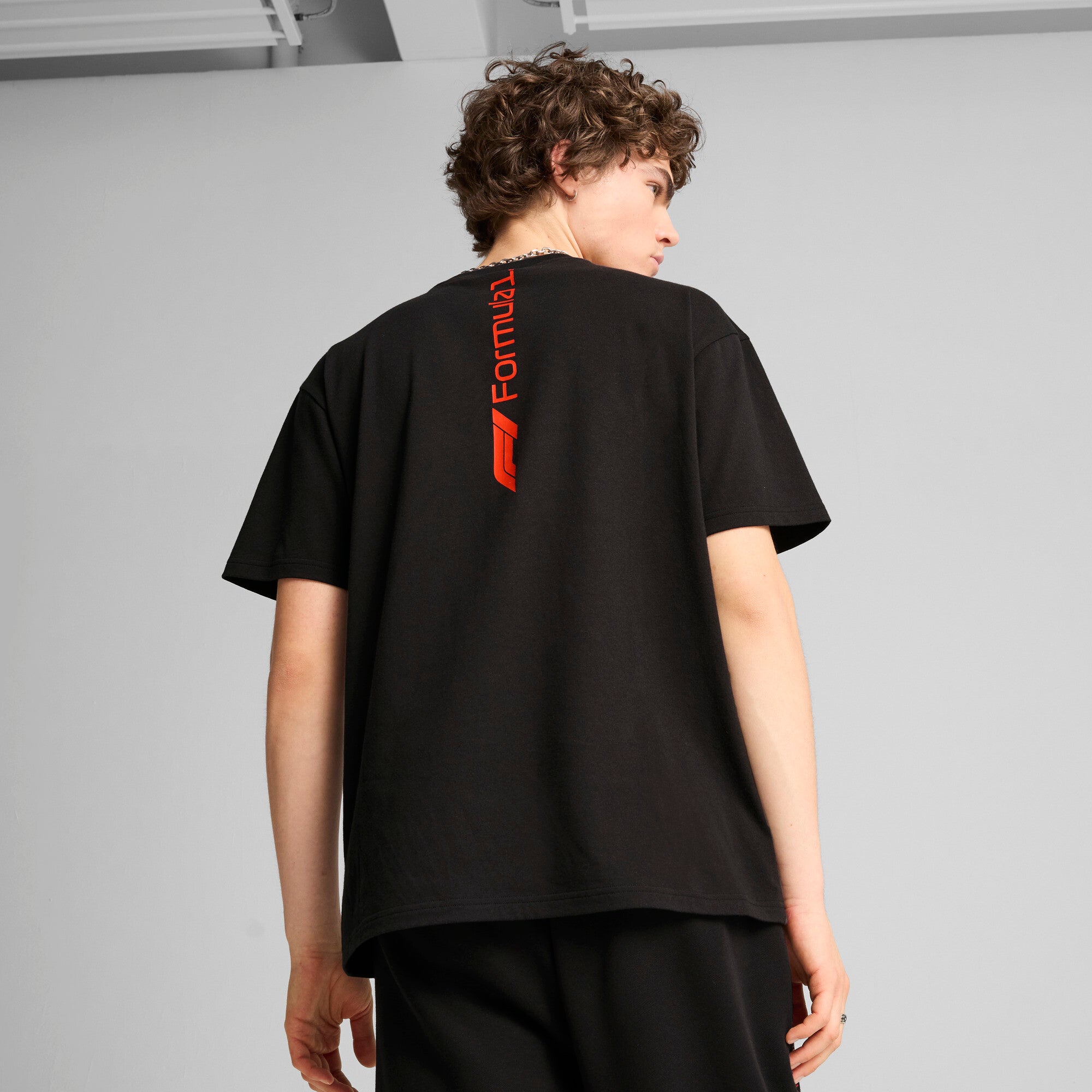 Puma F1® ESS+ relaxed graphic tee in black - Model Shot 02