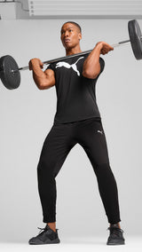 PUMA TAD ESSENTIALS solid cat tee men (525921) in black — model shot 3