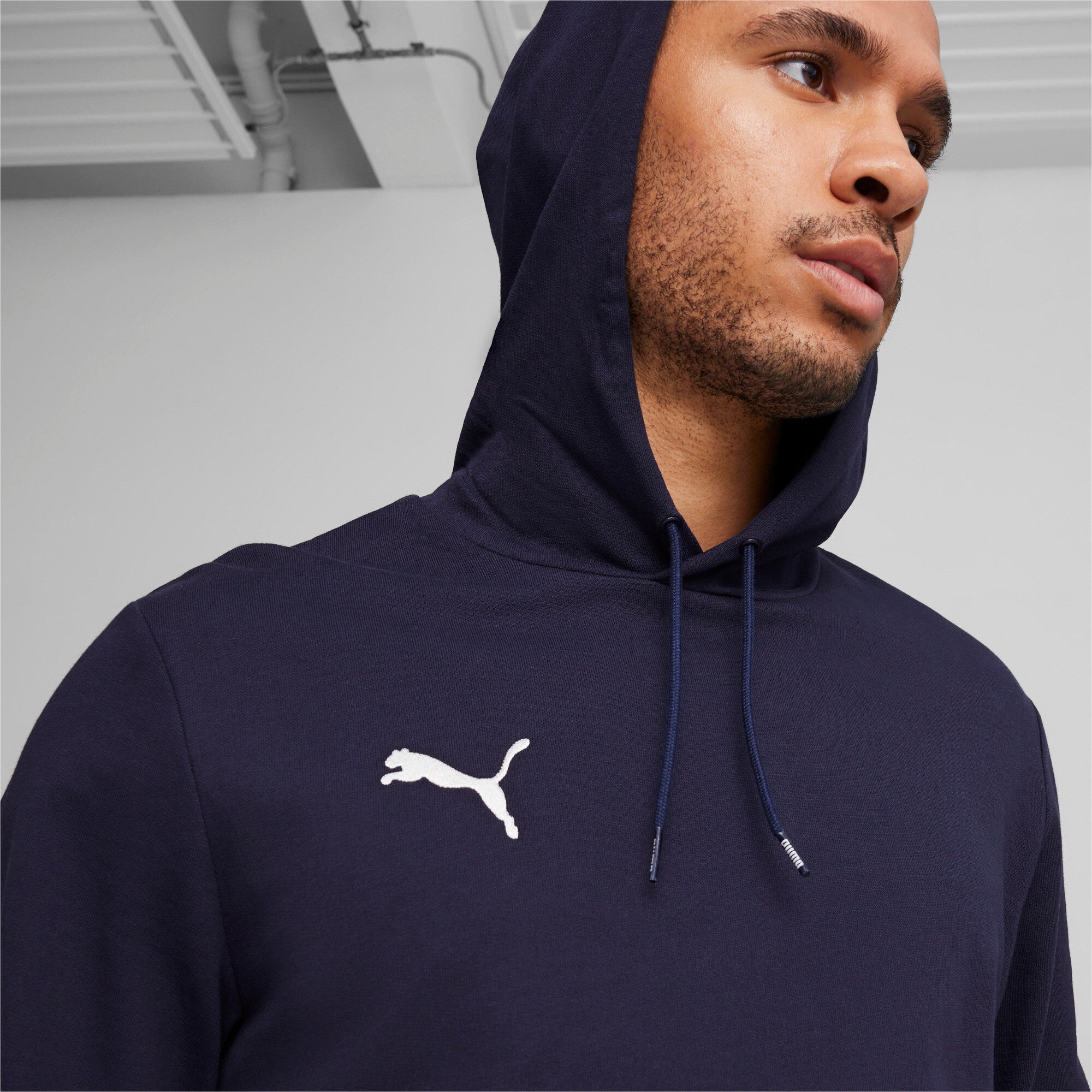 Puma teamGOAL casuals football hoodie in navy and white - Model Shot 02
