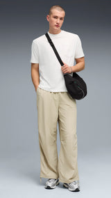 PUMA wardrobe essentials oversized parachute pants men in pebble gray — model shot 3