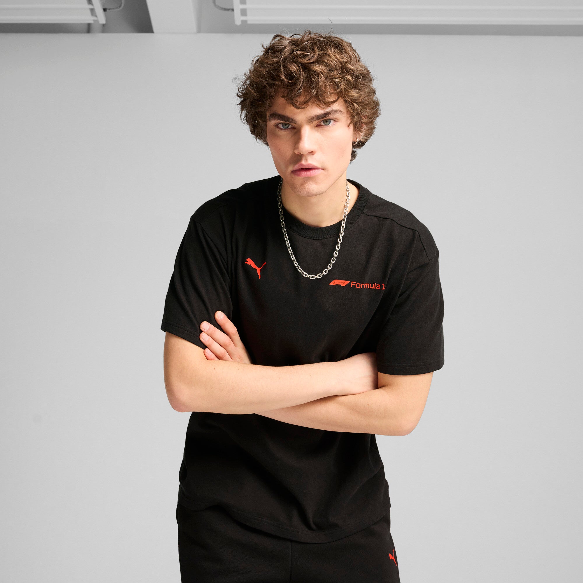 Puma F1® ESS+ relaxed graphic tee in black - Model Shot 01