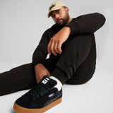 PUMA essentials no. 1 logo sweatpants men in black — model shot 2