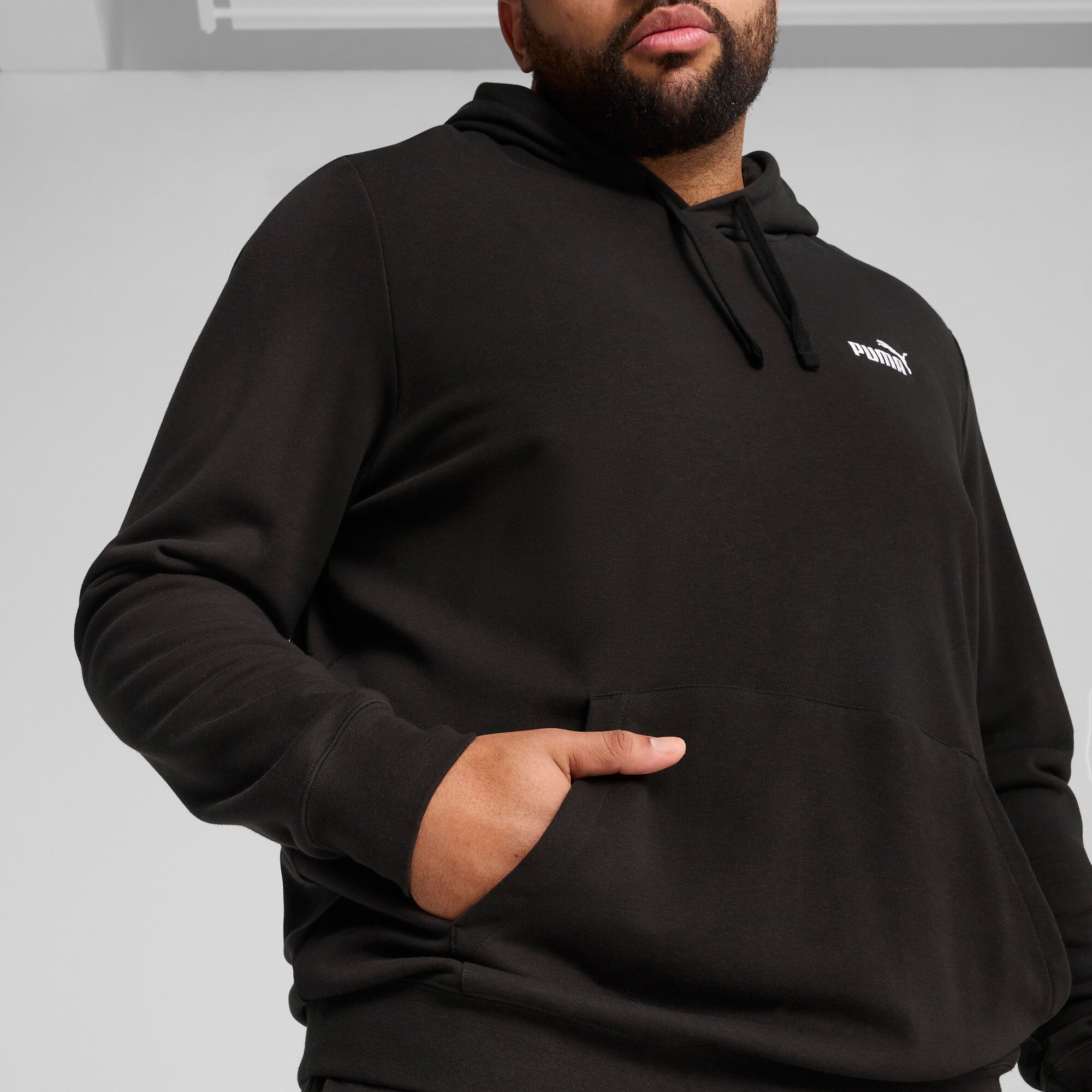PUMA essentials small no. 1 logo hoodie men in black — model shot 2