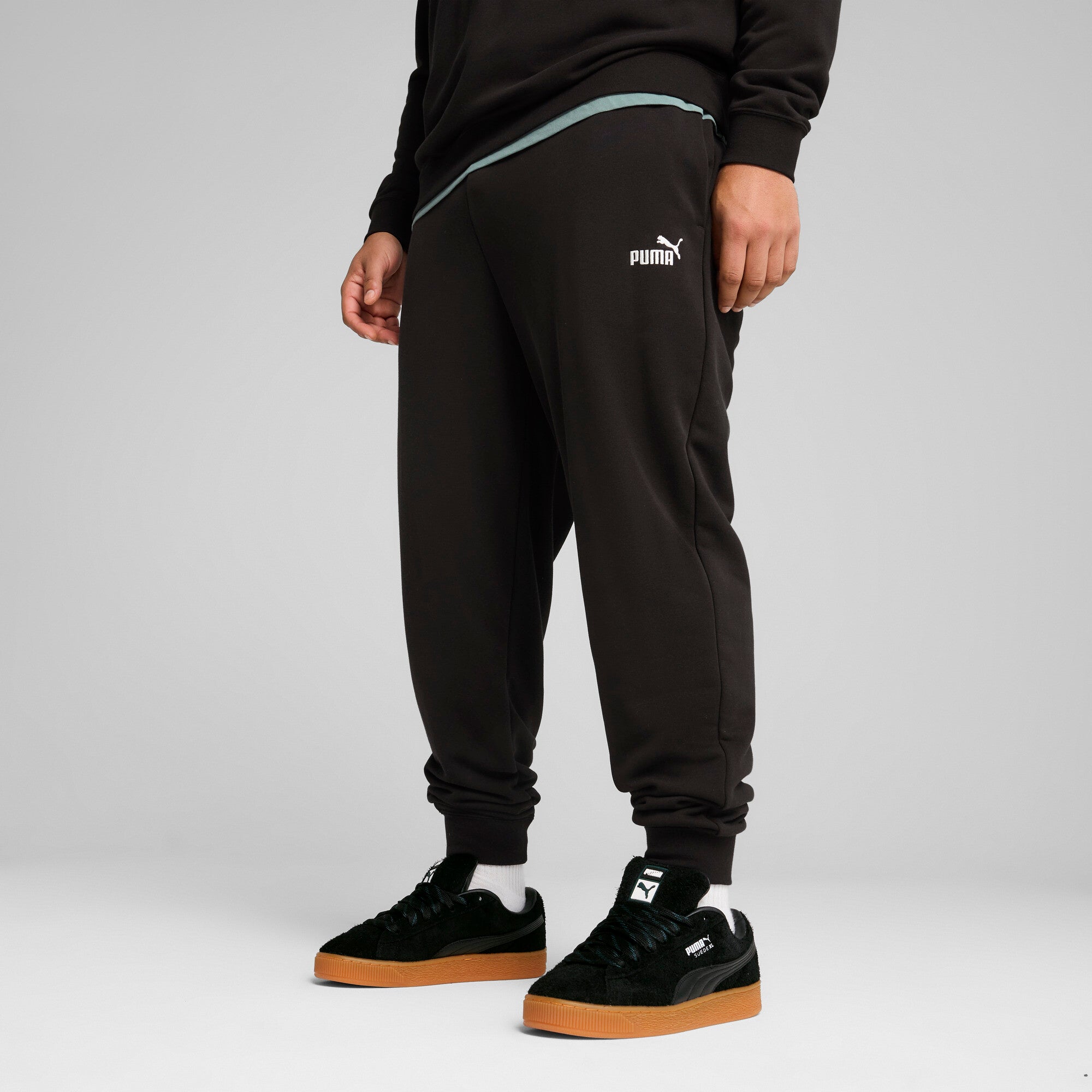 PUMA essentials no. 1 logo sweatpants men in black — model shot 3