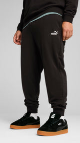 PUMA essentials no. 1 logo sweatpants men in black — model shot 3