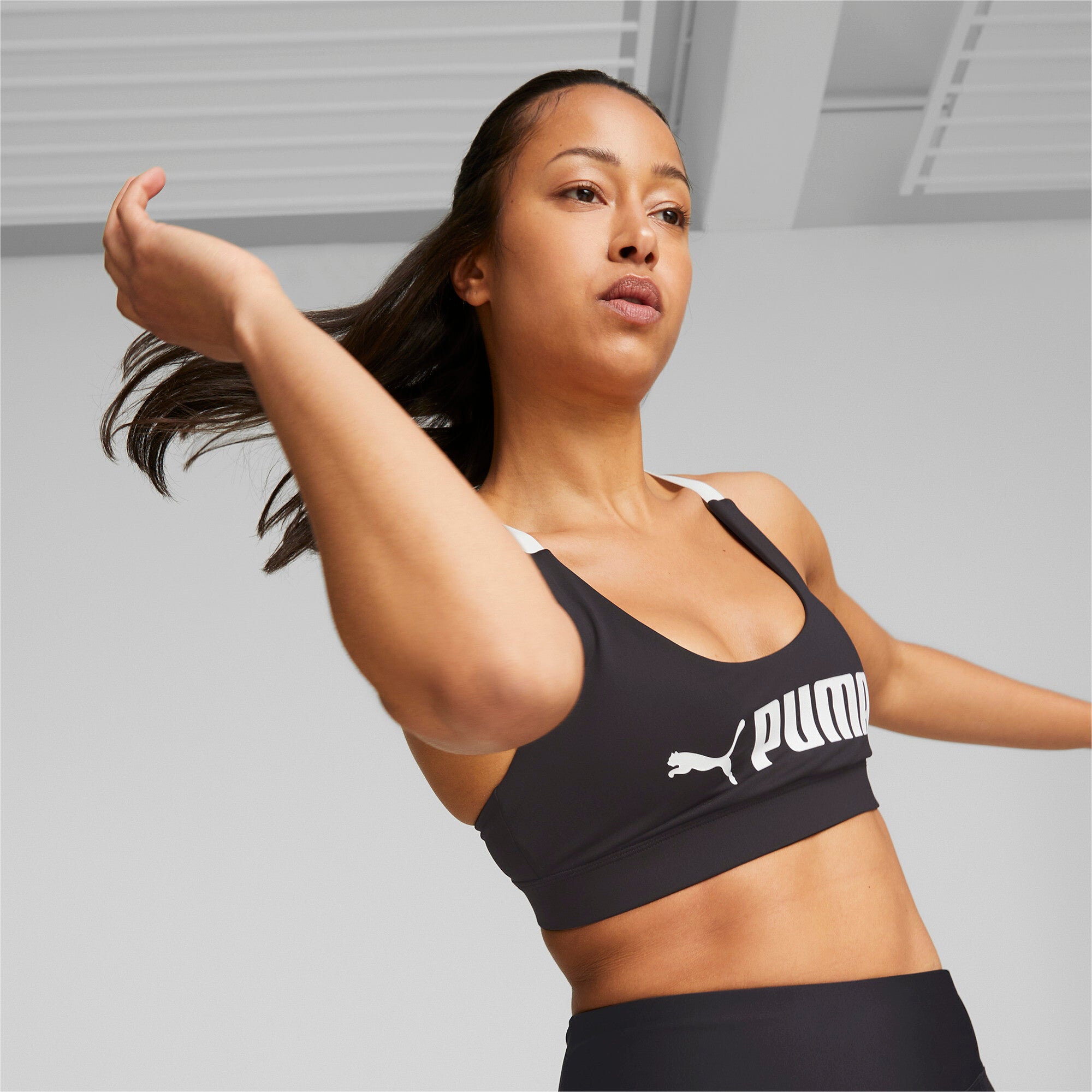 Puma fit mid impact training bra in black - Model Shot 01