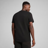 Puma sports legacy front graphic tee in black - Model Shot 02